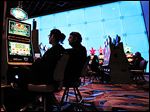  Monroe residents Susan and Klause Rose play the slots during Hollywood Casino’s first anniversary celebra-tion. Most players are from outside Lucas County.