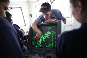 The cadets listen as the ship’s bosun, Richard Gray of Traverse City, Mich., explains how the training vessel’s radar system works.