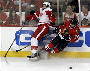 Detroit Red Wings defenseman Carlo Colaiacovo (28) and Chicago Blackhawks left wing Viktor Stalberg (25) collide during the third period in Game 7 of the NHL hockey Stanley Cup Western Conference semifinals.