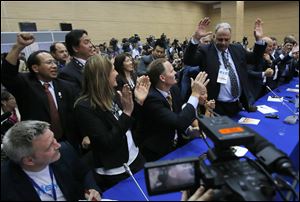 Members of International Wrestling federation react after the wrestling was announced one of the three candidate sports for  the 2020 Olympics at the SportAccord International Convention in St.Petersburg, Russia.