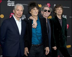 (L to R) Charlie Watts, Ronnie Wood, Keith Richards and Mick Jagger of the Rolling Stones pose for photos on their way into the Ziegfeld Theater to view 