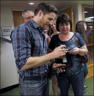 Actor and Perrysburg native Sam Jaeger gives an autograph to Yvonne Fey.