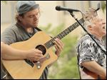  John Barile playing slide, left, and Bobby May, right, singing.    
