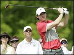  Rory McIlroy hits out of a bunker on the 13th hole. He was in trouble most of the day, finishing with a 78 in the first round.