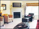  A gas fireplace with marble surround anchors the room while 10-foot ceilings tower above.