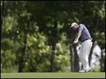  Bill Haas hits from the fairway on the ninth hole. He had a three-shot lead before storms stopped action in the second round.