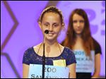  Samantha Schofield stands on stage as she spells the word ‘amphibious’ in the National Spelling Bee on Wednesday.