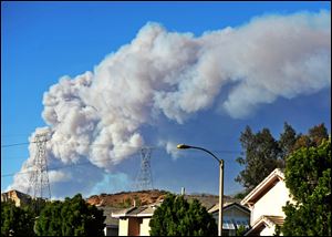 Smoke from the Powerhouse Fire is visible from the Saugus neighborhood of Santa Clarita, Calif.