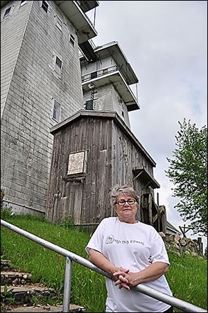 Donna Boglarsky, president of the Irish Hills Historical Society, is spearheading the effort to raise money to restore the towers.