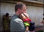  Bryan, Ohio resident Mark Holbrook holds the young African boy he and his wife plan to adopt later this year.