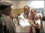  Kenny Cunningham, center, greets Bobby Clay of Omaha at the City League basketball reunion at SeaGate Convention Centre.