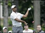  Tiger Woods reacts to a bad shot on the ninth hole during the third round of the Memorial. He finished with a 79 and is 16 shots behind Matt Kuchar.