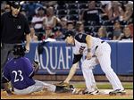  Toledo's Jordan Lennerton tags out Louisville's Denis Phipps at first  during Saturday’s contest.