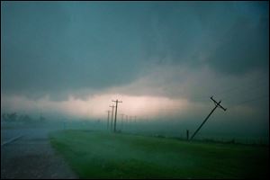 Tornadoes rolled in from the prairie and slammed Oklahoma City and its suburbs on Friday, killing a mother and baby and crumbling cars and tractor-trailers along a major interstate.