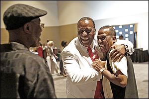 Kenny Cunningham, center, greets Bobby Clay of Omaha at the City League basketball reunion at SeaGate Convention Centre.