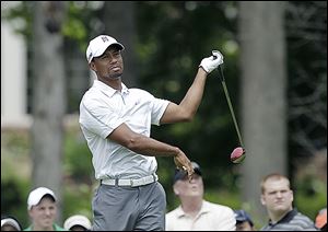 Tiger Woods reacts to a bad shot on the ninth hole during the third round of the Memorial. He finished with a 79 and is 16 shots behind Matt Kuchar.