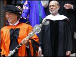  Princeton University's Dr. Jeff Nunokawa, Professor of English, holds the the school's ceremonial mace as Ben S. Bernanke, Chairman of the Federal Reserve, leads the processional out of Princeton University Chapel after giving the Baccalaureate address during an interfaith service Sunday in Princeton, N.J.