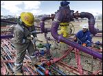  Workers tend to a well head during a hydraulic fracturing operation at an Encana Oil & Gas (USA) Inc. gas well outside Rifle, in western Colorado. In the fierce debates over the safety of fracking for natural gas, Pittsburgh’s Heinz Endowments is funding groups that say fracking can’t ever be done safely. It is also working with major energy companies and environmentalists who believe the drilling can be done without hurting the environment or public health.
