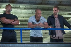 Dwayne Johnson , left, Vin Diesel, center, and Paul Walker star in 'Fast & Furious 6.'