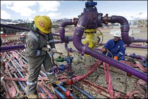 Workers tend to a well head during a hydraulic fracturing operation at an Encana Oil & Gas (USA) Inc. gas well outside Rifle, in western Colorado. In the fierce debates over the safety of fracking for natural gas, Pittsburgh’s Heinz Endowments is funding groups that say fracking can’t ever be done safely. It is also working with major energy companies and environmentalists who believe the drilling can be done without hurting the environment or public health.