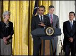  President Obama, accompanied by, from left, Health and Human Services Secretary Kathleen Sebelius, Education Secretary Arne Duncan, and Veterans Affairs Secretary Eric Shinseki, speaks during opening remarks of the White House mental health conference today in Washington.