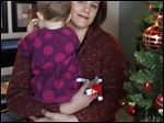  Christa Dias, with her 11-month-old daughter, was fired as a teacher in Catholic schools in 2010 after becoming pregnant through artificial insemination, which violated church doctrine. 