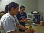  Stephanie Serda helps sixth grader Nathan Ponce with a science project at the Perrysburg Heights Community Association.
