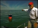  Mills Trophy Race chairman Ron Soka points out the location of  the Bicentennial Buoy marking the site of Commodore Perry's victory over the British in the Battle of Lake Erie. The buoy will mark part of the course.