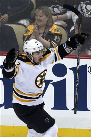 Boston Bruins' Brad Marchand celebrates his goal in the first period of Game 2 of the NHL hockey Stanley Cup Eastern Conference finals against the Pittsburgh Penguins.