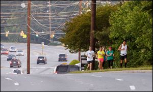 Shawna Block (in yellow) runs along Johnson Ferry Road in Marietta, Ga.
