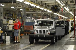 Jeep Wrangler models roll off the assembly line at Toledo’s Chrysler Toledo Assembly Complex. Chrysler Group LLC re­port­ed its best U.S. sales month ever in May for the vehicle with 16,272 sales.