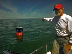 Mills Trophy Race chairman Ron Soka points out the location of  the Bicentennial Buoy marking the site of Commodore Perry's victory over the British in the Battle of Lake Erie. The buoy will mark part of the course.