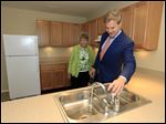  Tom Seeman and his mother Virginia Seeman, Sylvania, view an apartment during a dedication ceremony and open house for the new Collingwood Green Senior Community. Mr. Seeman, a St. Francis de Sales graduate, and his 11 siblings, lived in LMHA public housing developments until he was 18 years old.