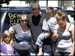  Terry Steinfurth, center, holds his daughter, Kylee Steinfurth, 4, as he prays for missing daughter  Elaina Steinfurth, 1, on Leonard Street. With them Tuesday were, from left, Layla Hungerford, 6; Becky Navaugh, Layla’s mom and Terry’s girlfriend, and Mary Schiewe, Elaina’s aunt.