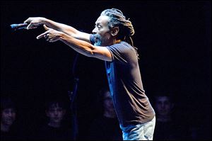 Vocalist Bobby McFerrin uses audience participation during a live concert.