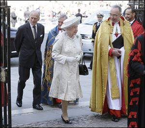 Britain's Queen Elizabeth II and her husband Prince Philip, left, arrive for service to celebrate the Queen's 60th anniversary of her coronation at Westminster Abbey, escorted by The Dean of  the Abbey  Dr. John Hall in London.