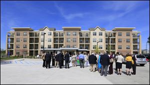 Dozens turn out for the dedication of the first phase of the $46 million Collingwood Green Senior Community at Division and Belmont in central Toledo on Tuesday. Residents can move in June 24.
