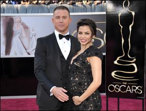 Channing Tatum and his then pregnant wife, Jenna Dewan-Tatum, stop on the red carpet at the 85th Academy Awards.