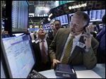  FILE - In this Friday, May 31, 2013 file photo, trader Robert Moran, right, works on the floor of the New York Stock Exchange. Global stock markets fell Wednesday June 5, 2013 as signs the U.S. Federal Reserve might scale back its super-loose monetary policy caused investors to trim equity investments. (AP Photo/Richard Drew, File)