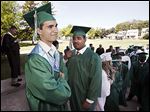  Valedictorian Marwan Mohamed, left, waits with Cody Zachariah Durden before Toledo Technology Academy’s commencement.