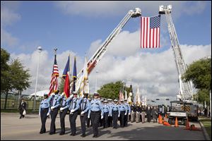 Firefighter's from around Houston and Texas walk during the firefighter's memorial procession today into Reliant Stadium.  As many as 40,000 people are expected to remember the four firefighters who died Friday
