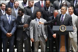 President Obama gestures as he welcomes the Super Bowl XLVII champion Baltimore Ravens football team to the South Lawn of the White House in Washington, today.