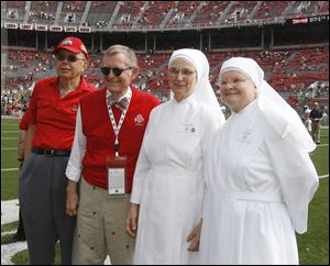 Left to right Stan Joehlin,  Ohio State president Gordon Gee, along with Little Sisters of the Poor Sr. Cecilia Sartorius and Sr. Margaret Banar prior to the football game against Toledo Saturday, 09/10/11, in Columbus, Ohio.