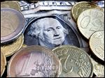  Euro coins and dollar bills are seen.