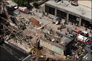Rescue personnel work the scene of a building collapse in downtown Philadelphia, Wednesday, June 5, 2013.