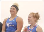  Liberty-Benton’s Alex DeVincentis, left, and Liz Streaker collect their first- and third-place medals, respectively,  in the discus at the Division II state championship meet in Columbus.