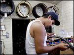  Martin Martinez fixes his bike at the Bicycle Kitchen in Los Angeles. Many millennials have developed a penchant for thrift.