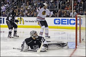 Chicago Blackhawks center Michal Handzus (26), of the Czech Republic, who got an assist, celebrates a goal by Marion Hossa against Los Angeles Kings goalie Jonathan Quick and defenseman Drew Doughty (8) in the the third period of Game 4.