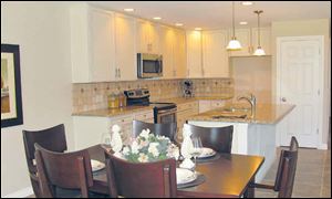 This lovely island kitchen is open to the dining area. Both are open to the great room.  