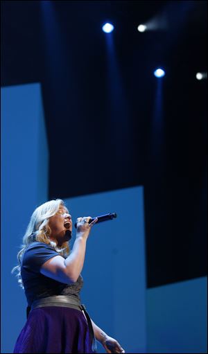 Musician and former American Idol winner Kelly Clarkson performs during the Wal-Mart shareholders meeting in Fayetteville, Ark., Friday, June 7, 2013. (AP Photo/Gareth Patterson)
